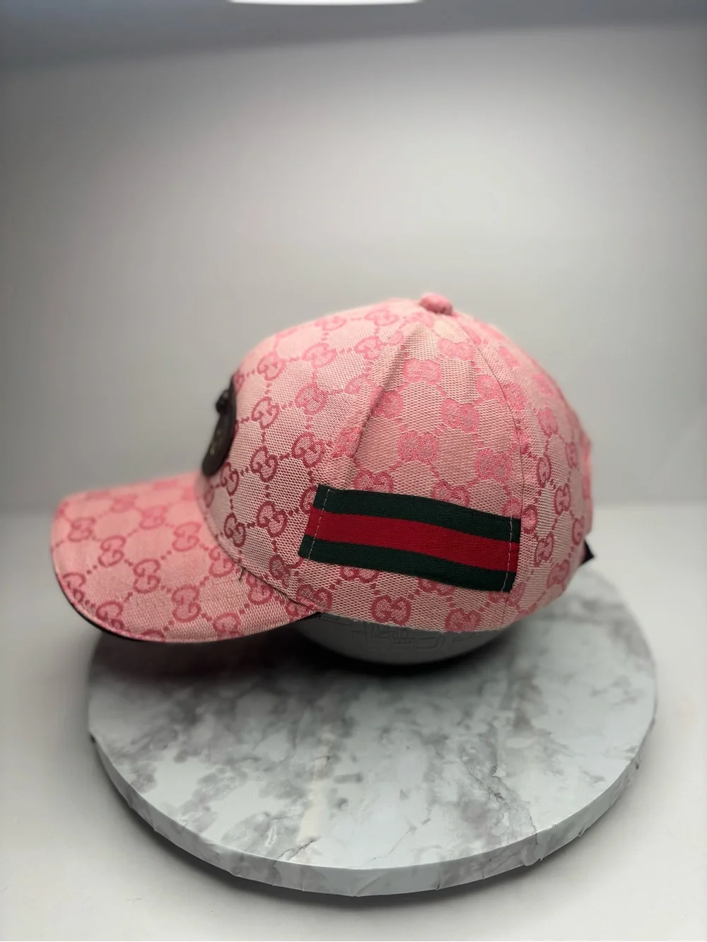 Gucci baseball cap featuring a pink GG monogram canvas and a leather patch